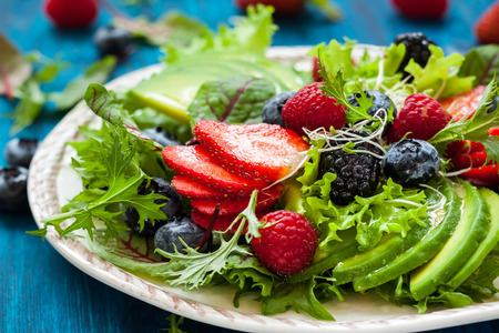 Mixed salad leaves with berries, avocado and honey-mustard dressingの写真素材