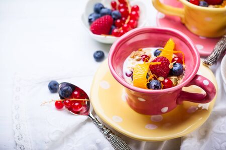 Healthy breakfast with muesli, yogurt and fresh berries in cupの写真素材