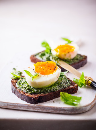 Boiled egg with pesto on toast  for breakfastの写真素材
