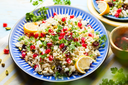 Cauliflower couscous with dried cranberry, pomegranate, pistachio and pine nutの写真素材