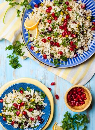 Cauliflower couscous with dried cranberry, pomegranate, pistachio and pine nutの写真素材