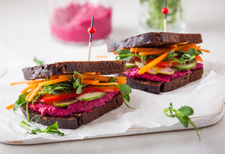 gluten free vegan sandwiches with beet hummus, raw vegetables and sproutsの写真素材