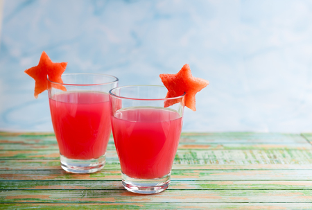 Watermelon drink in glasses with slices of watermelon in star shapeの写真素材