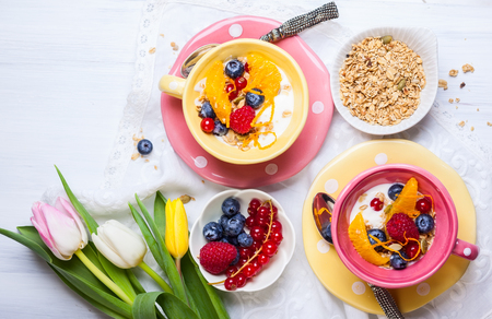 Healthy breakfast with muesli, yogurt and fresh berries in cupの写真素材