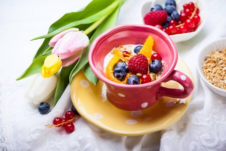 Healthy breakfast with muesli, yogurt and fresh berries in cupの写真素材