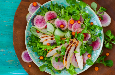 Grilled chicken salad  with cucumber and watermelon radishの写真素材
