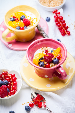 Healthy breakfast with muesli, yogurt and fresh berries in cupの写真素材