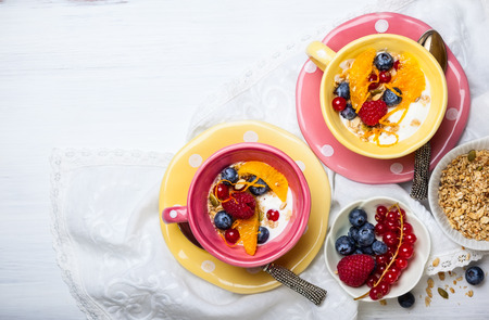 Healthy breakfast with muesli, yogurt and fresh berries in cupの写真素材