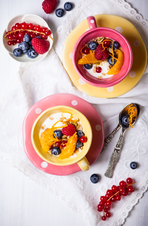 Healthy breakfast with muesli, yogurt and fresh berries in cupの写真素材