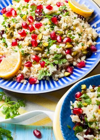 Cauliflower couscous with dried cranberry, pomegranate, pistachio and pine nutの写真素材