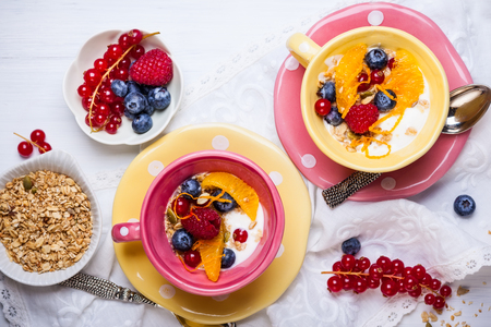 Healthy breakfast with muesli, yogurt and fresh berries in cupの写真素材