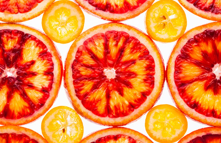 Slice of red orange and kumquat on a white backgroundの写真素材