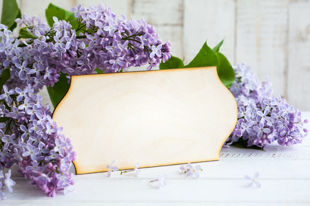 Wooden greeting card and wreath frame with lilacの写真素材