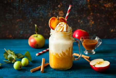 Apple cider float with caramel sauce and stick of cinnamonの写真素材