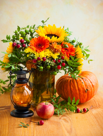 Autumn still life with flowers, pumpkin and fruitsの写真素材