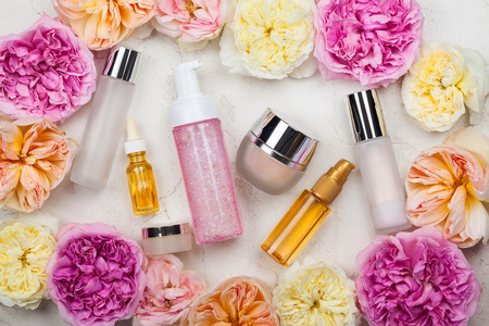 Overhead view of cosmetic set and flowersの写真素材