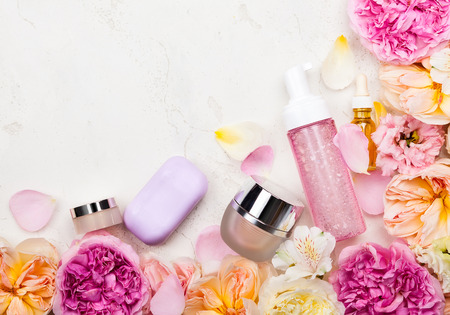 Overhead view of cosmetic set and flowersの写真素材