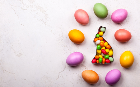 Easter concept with natural dyed easter eggs and candy. Flat layの写真素材