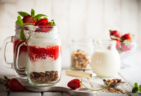 Healthy breakfast in a Mason jar with yogurt, strawberry puree and muesliの写真素材