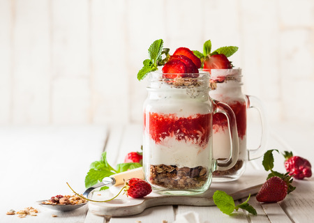 Healthy breakfast in a Mason jar with yogurt, strawberry puree and muesliの写真素材