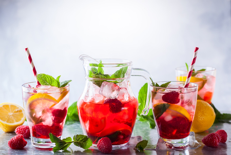 Raspberry lemonade in glasses with fresh berries and mint leavesの写真素材