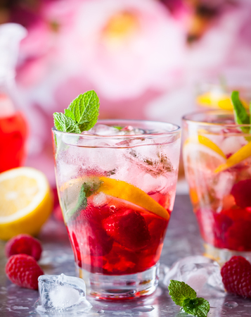 Raspberry lemonade in glasses with fresh berries and mint leavesの写真素材