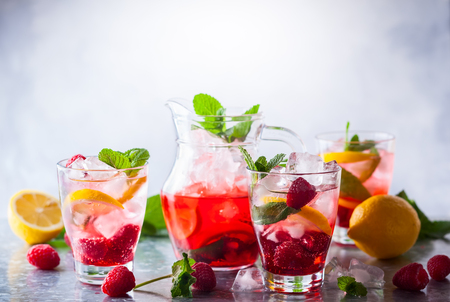 Raspberry lemonade in glasses with fresh berries and mint leavesの写真素材