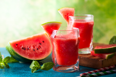 Summer refreshing watermelon drink in glasses with mint and drinking strawの写真素材