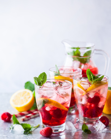 Raspberry lemonade in glasses with fresh berries and mint leavesの写真素材