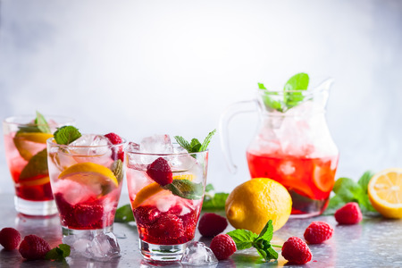 Raspberry lemonade in glasses with fresh berries and mint leavesの写真素材
