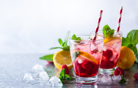 Raspberry lemonade in glasses with fresh berries and mint leavesの写真素材