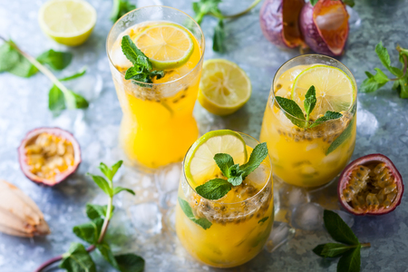 Passion fruit lemonade garnished with lime and mintの写真素材
