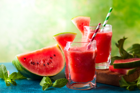 Summer refreshing watermelon drink in glasses with mint and drinking strawの写真素材