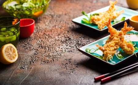 Shrimps tempura with spicy chili sauce on blue plate.  Seafood tempura dish of traditional asian cuisine .の写真素材