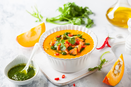 Pumpkin and sweet potato soup with coriander oil and chili pepperの写真素材