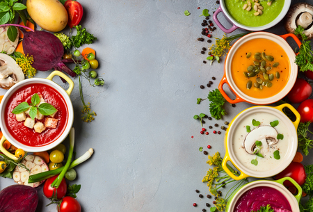 Variety of colorful vegetables cream soups and ingredients for soup. Top view. Concept of healthy eating or vegetarian food.の写真素材