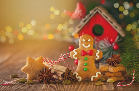 Christmas homemade gingerbread cookies and spices on the wooden background