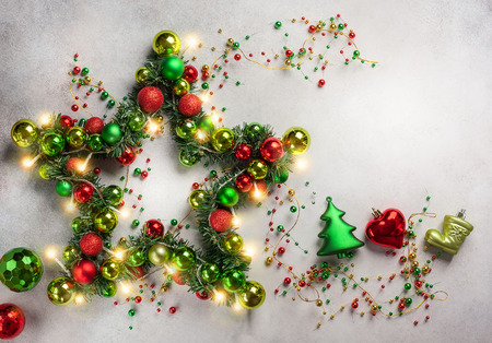 Decorative Christmas Star with colored baubles, christmas tree branches 
and lights. Top view.の写真素材