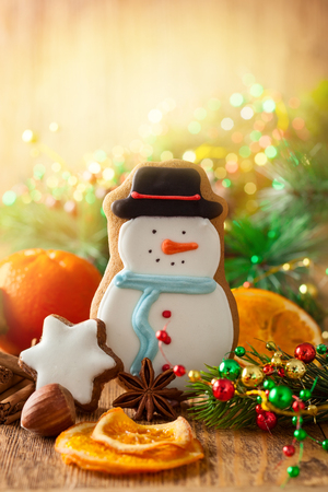 Snowman gingerbread biscuit,tangerine,nuts and spices for Christmas.の写真素材