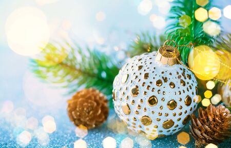 Christmas concept with silver bauble, fir cones and festive fir treeの写真素材
