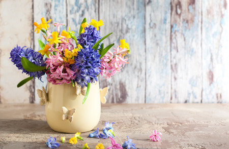 Fresh beautiful spring flowers in vase on  table. Easter decoration for home.の写真素材