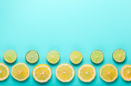 Slices of fresh lemon and lime pattern on pastel blue background in minimalist style. Flat lay, copy...