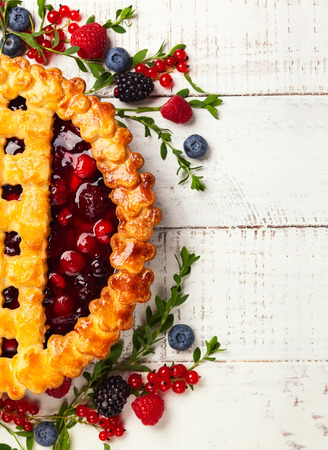 Homemade summer berry pie on rustic wooden background with copy space. Top view.の写真素材