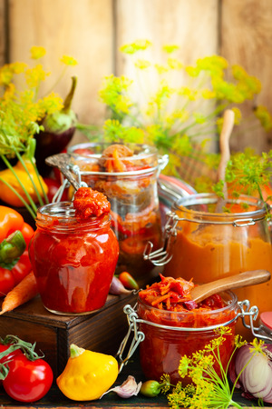Autumn homemade preserved vegetables in glass jarsの写真素材