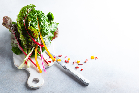 Various different coloured chard leaves on a gray surfaceの写真素材