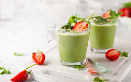 Matcha green tea panna cotta  with coconut milk topped with strawberry  in  glasses.の写真素材