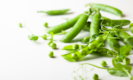 Fresh green  peas pods and  green peas with  sprouts on white woodenの写真素材