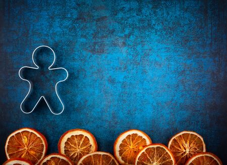 Winter concept with Christmas cookies shape and spices on blue background. Top view with copy space.の写真素材