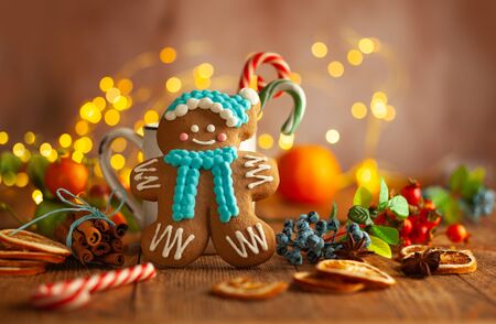 Christmas gingerbread cookies with Christmas decorations on wooden background. Traditional Christmas...