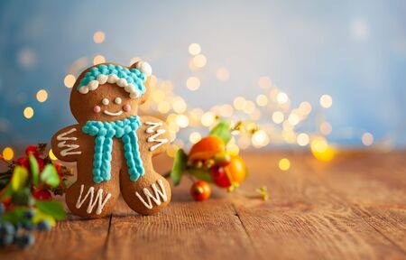 Christmas gingerbread cookies with Christmas decorations on wooden background. Traditional Christmas baking.の写真素材